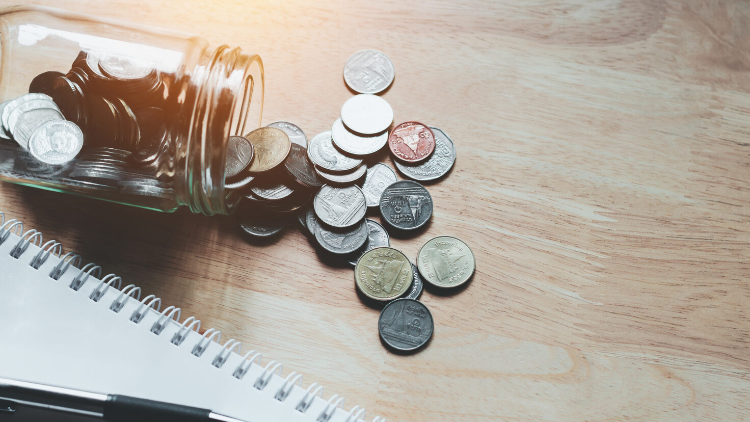 concept saving money business finance with pen and notebook