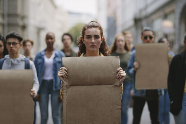 People demonstrating with blank placards