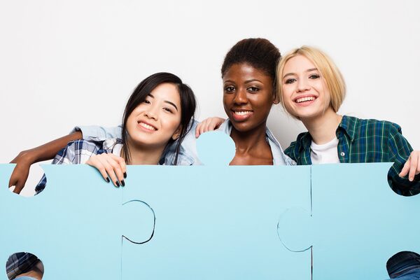 group of three different ethnic woman waiting in chairs with puzzle pieces