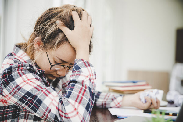 Young frustrated woman working at office